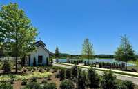 Adorable "Gate House" with lush landscaping and view of pond with fountains welcomes you home. Come feed the geese!