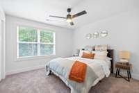 Second suite upstairs features ceiling fan, full bathroom and walk-in closet