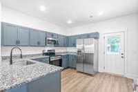 Big spacious kitchen, lots of custom craftsman cabinets with shaker style doors and soft close drawers, stainless steel appliances and granite counters.