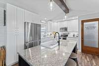 The kitchen island and counter tops provide plenty of space for food prep and baking.