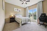 Bedroom 2 features soft carpet flooring, a large window, and a ceiling fan for year-round comfort. 2028 Martins Bend Dr.  La Vergne, TN 37086