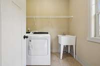 The laundry room includes a convenient utility sink and ample space for organization. Washer and dryer convey! 2028 Martins Bend Dr.  La Vergne, TN 37086