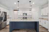 Granite countertops, sleek backsplash, and upgraded pendant lighting