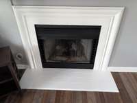 the gas turn off valve is just to the left of the fireplace.