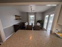 The ample dining space joins the kitchen with a large bar joining the kitchen counter