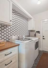 Built-in upper and lower cabinetry in the laundry.  The door leads to the attached two car garage.