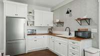There is a kitchenette with full size refrigerator, sink and microwave.   Perfect space for guests or inlaws!
