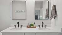 Quartz counters, recessed bowl sinks, two mirrors and black fixtures are on trend.