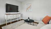 The living area is spacious.  There are stained concrete floors throughout.