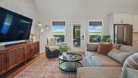 The great room overlooks the expansive covered porch and the treeline to the rear of the property.