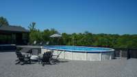 Above ground pool is semi-recessed.  The expansive pool and firepit area is designed for entertaining.