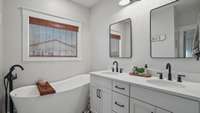 The en-suite bath is a spa oasis with a soaking tub, dual sink vanity and separate tile shower.