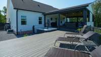 The deck has plenty of room for lounging and/or sunning and provides zero entry access to the hot tub and pool.