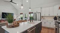 Complimentary blue cabinets on the island are a centerpiece.