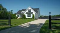 The charming curb appeal will draw you right in.  Notice the lighting atop the posts.  This entrance was designed to add a driveway gate, if you so please.