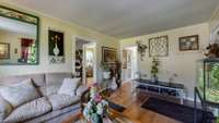 Hardwood floors continue into the Hallway and is present under the carpeted Bedrooms.