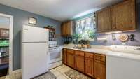 Tiled Kitchen floors accent your Refrigerator, Stove/Oven, plus the Washer/Dryer.