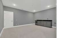 The Media/Bonus room with a mini fridge and wet bar.