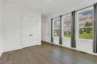 the 2nd bedroom on the main floor featuring beautiful windows and natural light.