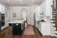 Stainless steel appliances and connected ELFA-organized pantry