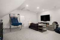 Entry to media room comes from double staircase in house, which leads directly into the kitchen