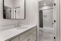 Updated jack and jill full-bath upstairs with beautiful tile design in shower