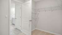 A LARGE WALK-IN CLOSET OFF THE PRIMARY BATH PROVIDES PLENTY OF SPACE FOR CLOTHES, SHOES, AND ACCESSORIES