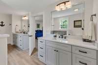 Primary bath, with quartz countertops and tile flooring