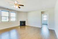 Spacious living area with natural light and cozy fireplace.