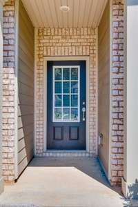 Charming entryway with a stylish glass-panel door.