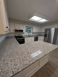 Kitchen with all new counters, backsplash, and appliances.