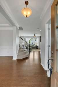 Inviting Hardwood Foyer with Formal Dining Room to the left and Private office to the Right