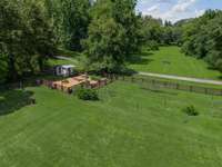 Chicken coop, raised-bed garden, and vineyard area.