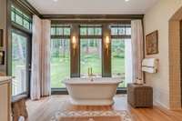 Beautiful and spa-like, this relaxing primary bath offers tranquil views of the private, serene backyard—your own personal retreat.