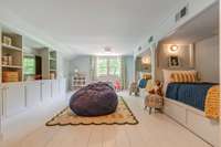 A fun and cozy bonus room above the garage — the perfect little getaway for games, guests, or giggles. The built-ins below each bunk have trundle beds to sleep additional guests.