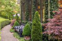 Romantic vines adorn the exterior of the home, creating a peaceful exterior inviting you to connect with the beauty of nature