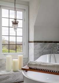 Stunning views of the Natchez Bridge and rolling hilltops from windows throughout the home