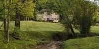 A wet-weather creek lines the width of the property, adding to the serene surroundings