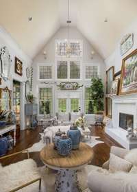 Two-story Great Room adorned with antiques from Europe - all of which can come with the home if desired