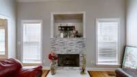 A closeup view of this beautiful fireplace and an opening for your tv.