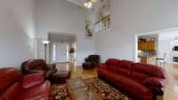 This vast living room opens to the breakfast area and notice the balcony from the second floor.