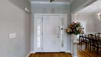 This lovely door with beautiful sidelights and high ceilings offer a grand entrance.