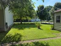 A view of the side yard(left side of the house looking back at the street.