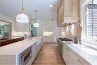At the heart of the home, a showstopping chef's kitchen features sleek Thermador appliances, custom cabinetry, and double islands-perfect for entertaining or gathering with family.