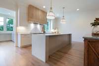 At the heart of the home, a showstopping chef's kitchen features sleek Thermador appliances, custom cabinetry, and double islands-perfect for entertaining or gathering with family.