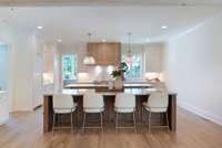 At the heart of the home, a showstopping chef's kitchen features sleek Thermador appliances, custom cabinetry, and double islands-perfect for entertaining or gathering with family.