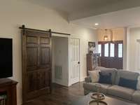 Living Room/ Barn door creates extra privacy for two bedrooms