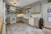 SO CUTE!!! Farmhouse sink, tile floors...