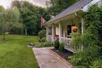 Beautiful sidewalk front entry way brings all to your welcoming covered front porch