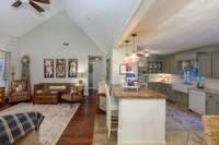 Standing near your primary bedroom hallway looking out into your greatroom and kitchen/dining area